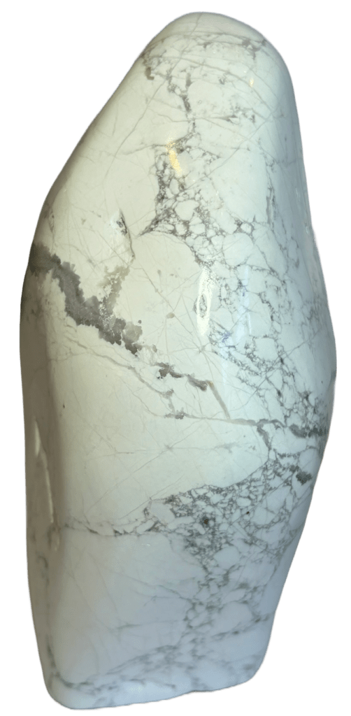 Natural polished white howlite freeform sculpture sians emporium Polished natural white howlite freeform standing stone showing distinct grey spiderweb veining across a porcelain finish