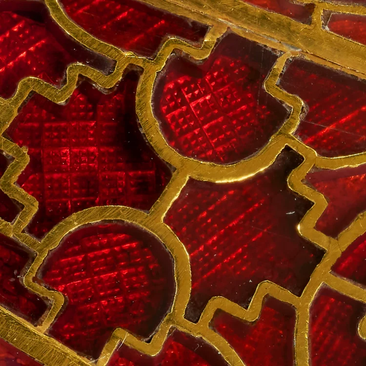Close-up of red garnet cloisonné inlay set within gold cells in early medieval jewellery.