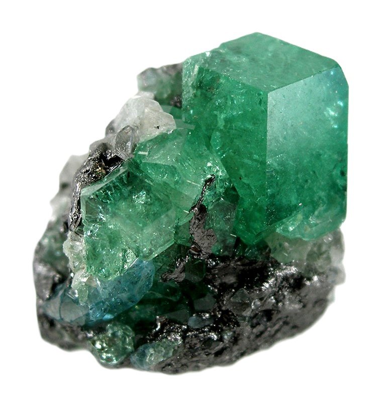 Raw Tsavorite crystal growing on its natural rock matrix with transparent green cubic crystals.