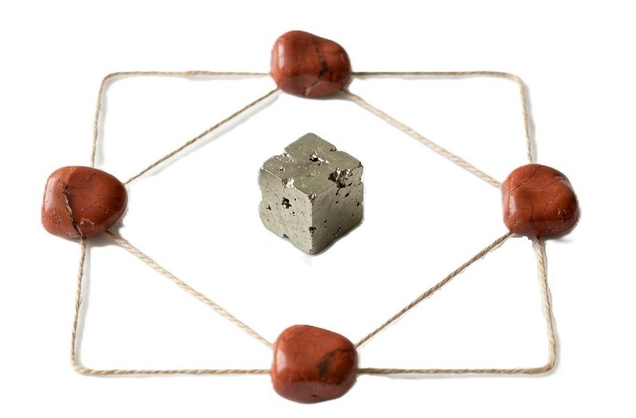 Jasper and pyrite cube sacred geometry crystal grid sians emporium Sacred geometry crystal grid featuring four polished red jasper stones and a natural pyrite cube center connected by twine lines on a white background